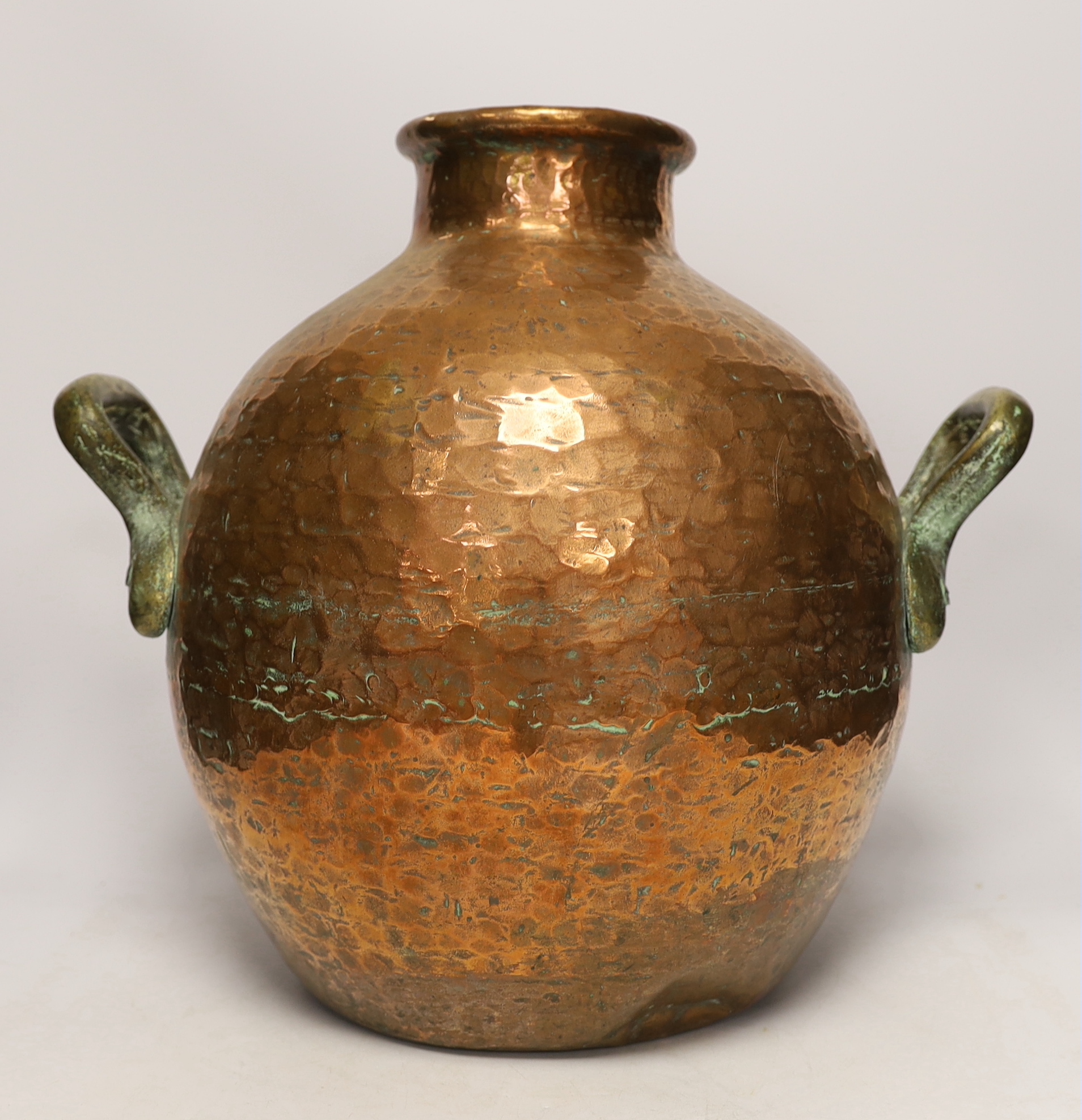 A copper vessel with double brass handles, 39cm high